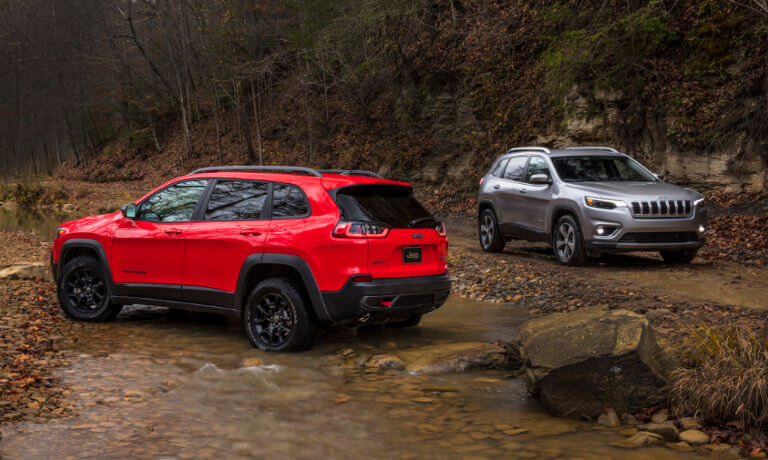 2019 Jeep Cherokees near stream Red and Grey 2019 Jeep Cherokees