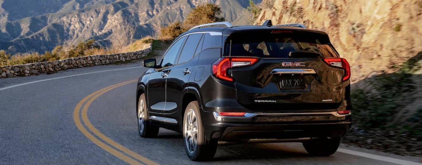 A black 2023 GMC Terrain from the rear at an angle.