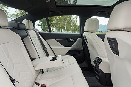 Interior of the BMW 5 Series showcasing premium materials, ambient lighting, and a driver-focused cockpit designed for absolute elegance and comfort.