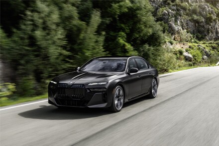 Experience the smooth and effortless drive of the BMW 7 Series, gliding down the road with refined luxury and precision engineering.