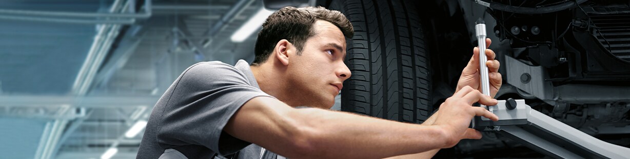 BMW undergoing precise wheel alignment service at Patrick BMW service center to ensure optimal tire performance and vehicle handling.