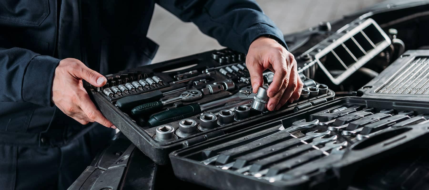 BMW technician inspecting automotive tools in a well-organized tool box at Patrick BMW.