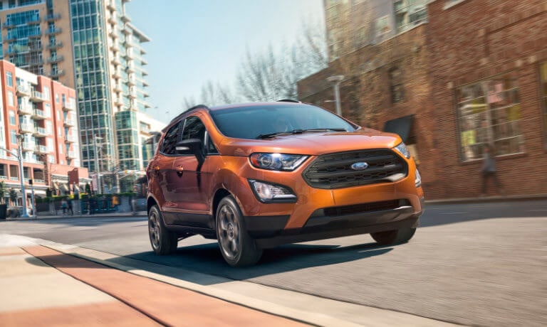 Orange 2019 Ford EcoSport driving down street