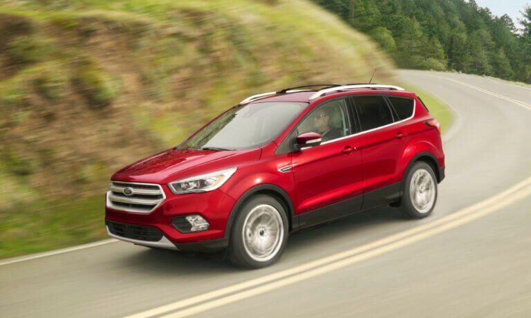 Red 2019 Ford Escape driving down hill