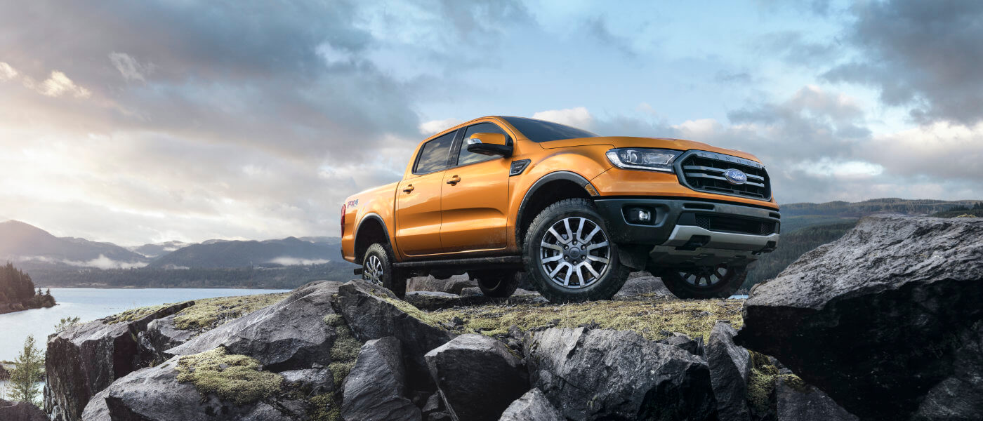 Orange 2019 Ford Ranger parked on rocks near water