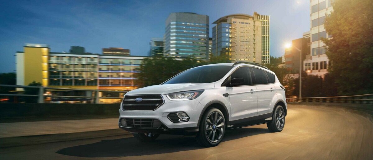 2019 Ford Escape driving out of city in the evening
