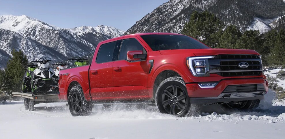 2023 Ford F-150 in red driving through snow.png