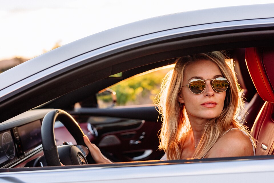 Woman with sunglasses in driver's sear of Mercedes-Benz.jpeg