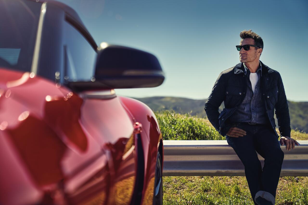 Man sitting ourdoors by partial image of Toyota Supra MY2020.jpg