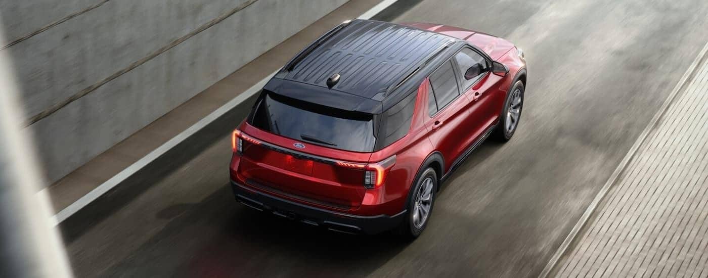Used Ford for Sale Near Springfield 2024 Ford Explorer - Highway.jpg Used red 2024 Ford Explorer for sale near Springfield driving on a highway ramp