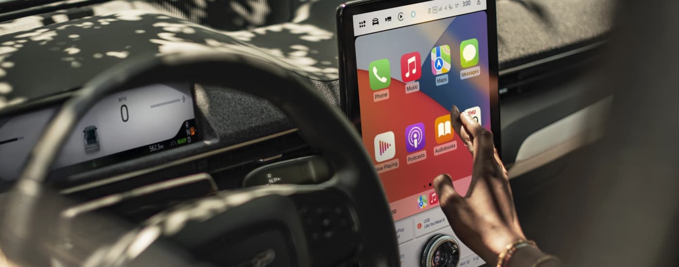Ford%20Dealer%20Near%20Springfield%202025%20Ford%20Mustang%20Mach-E%20-%20Infotainment%20(1).jpg Person using the infotainment screen in a 2025 Ford Mustang Mach-E at a Ford dealer near Springfield
