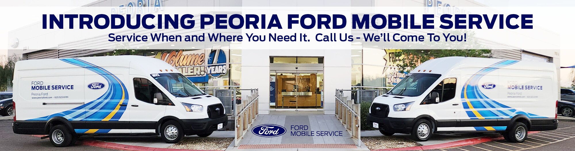 Two Ford vans parked in front of the Peoria Ford dealership