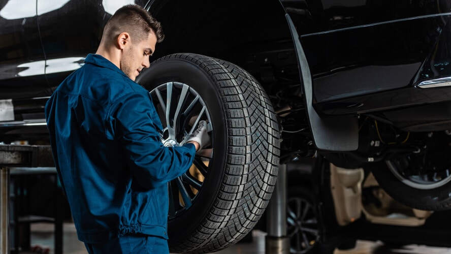 Peoria Subaru mechanic checking car tire