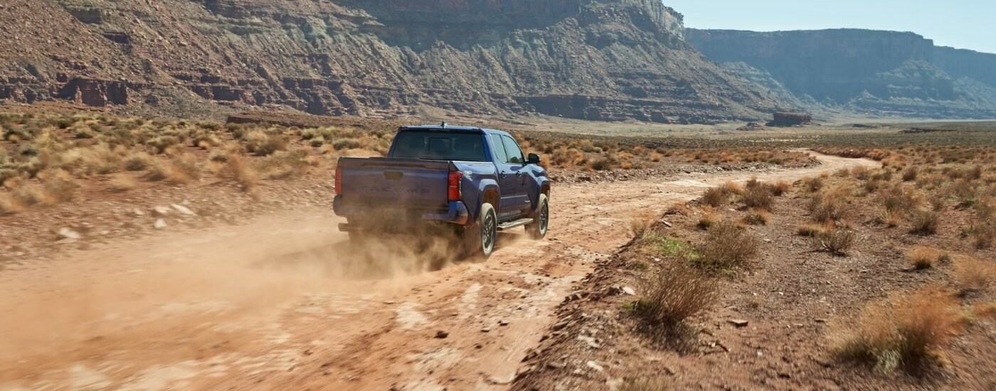 A blue 2025 Toyota Tacoma from the rear.
