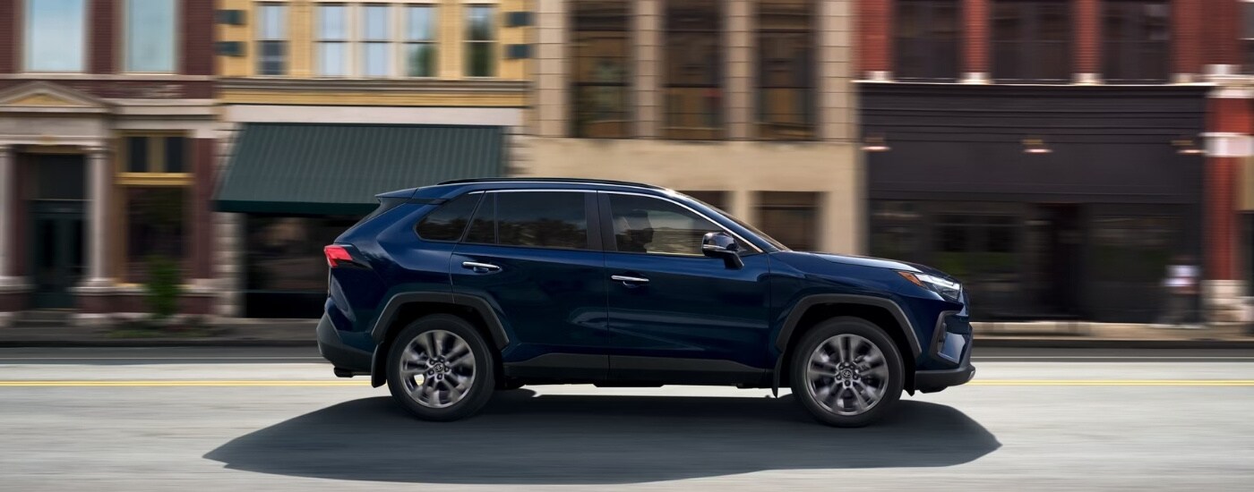 A blue 2024 Toyota RAV4 from the side.