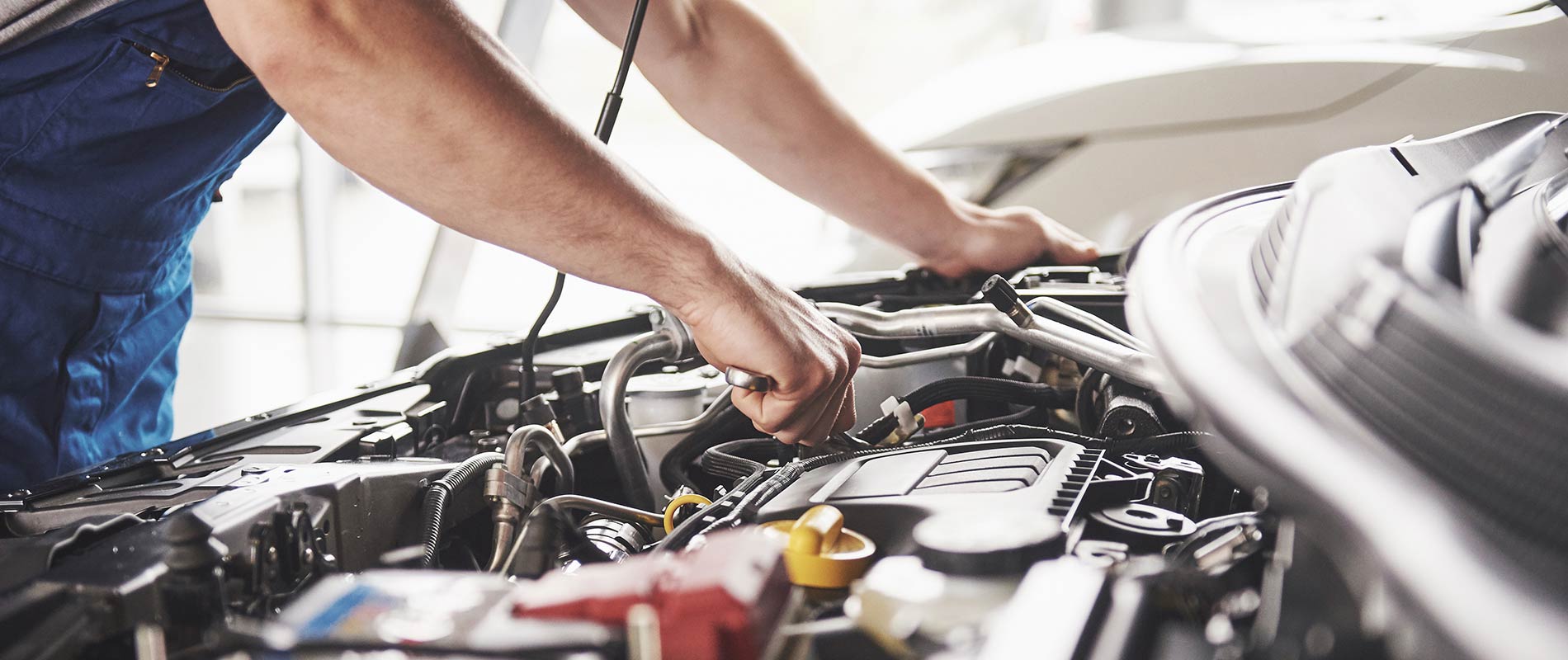 Why Service With Peoria Toyota? Toyota technician performing maintenance on an engine