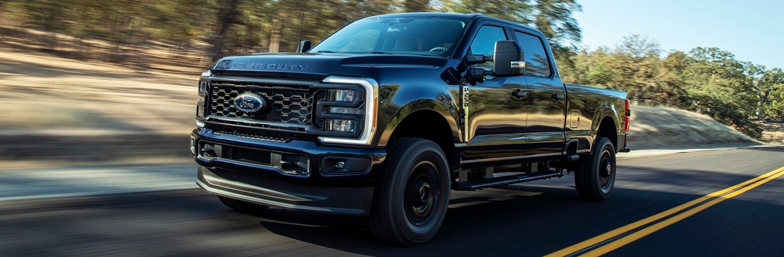 Find a Ford Truck in Peru IN Ford Super Duty truck driving down a scenic road