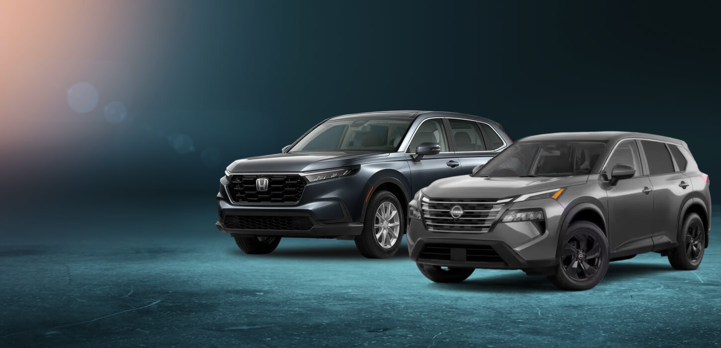 Front three-quarter view of a Meteorite Gray Honda CR-V EX and a Gun Metallic Nissan Rogue SV positioned on a blue studio.