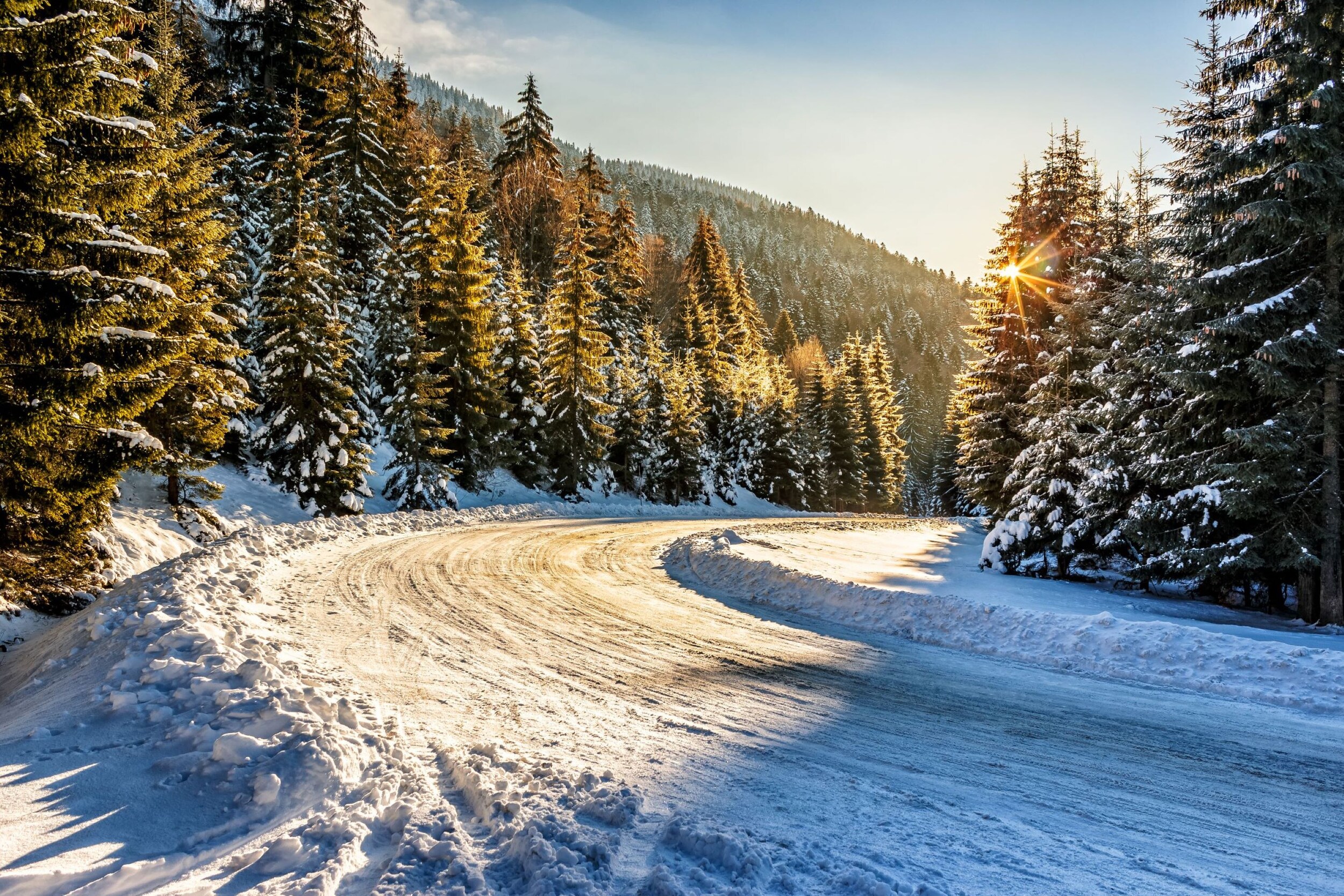 AdobeStock_115337229 v2.jpeg A snow packed road in the mountians.' class=