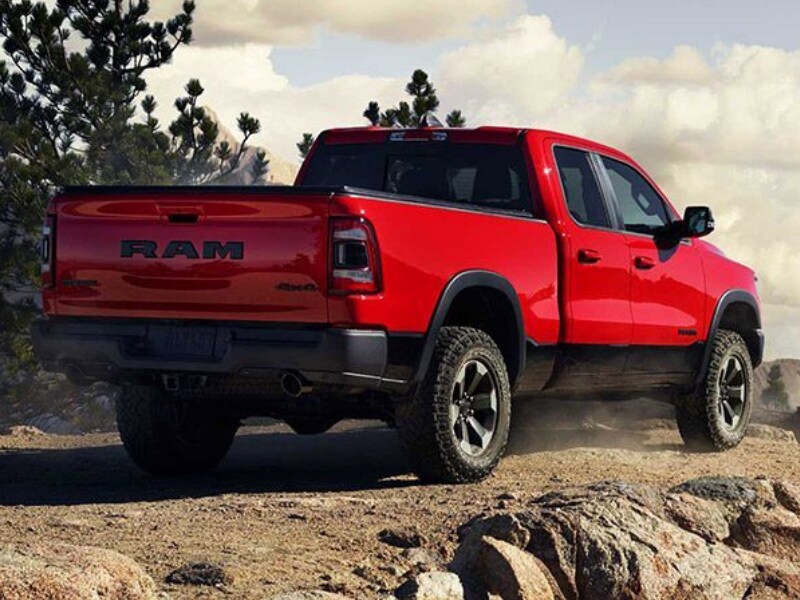 Exterior view of a 2019 Dodge Ram 1500 parked on the edge of a mountain cliff