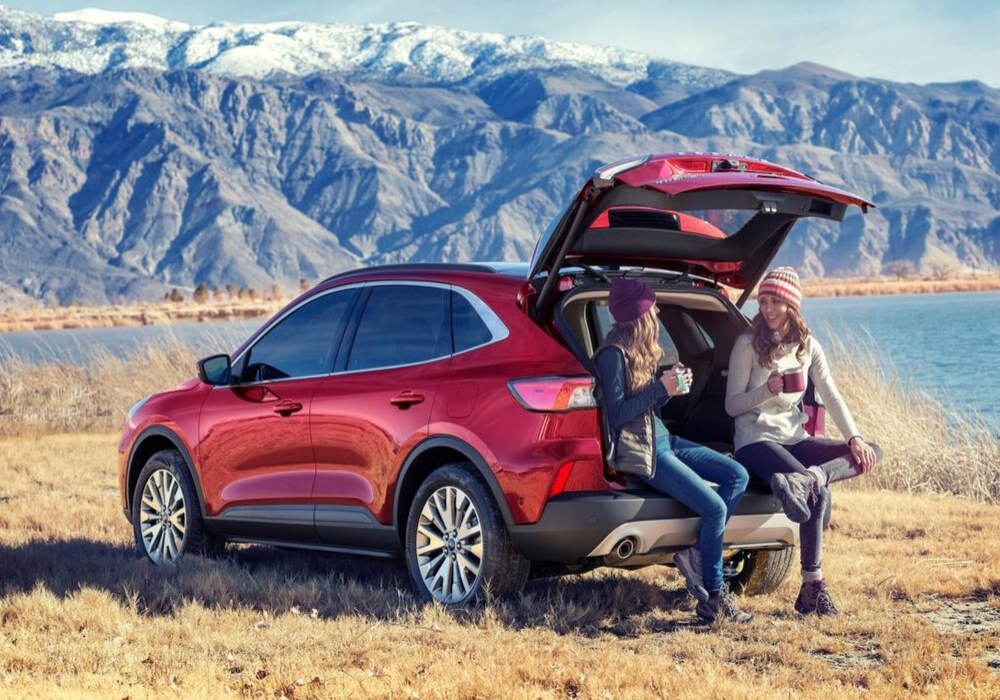 2020 Ford Escape Exterior.png 2020 Ford Escape exterior red color parked grassy hill cold morning driver passenger drinking coffee Rocky mountains range in distance