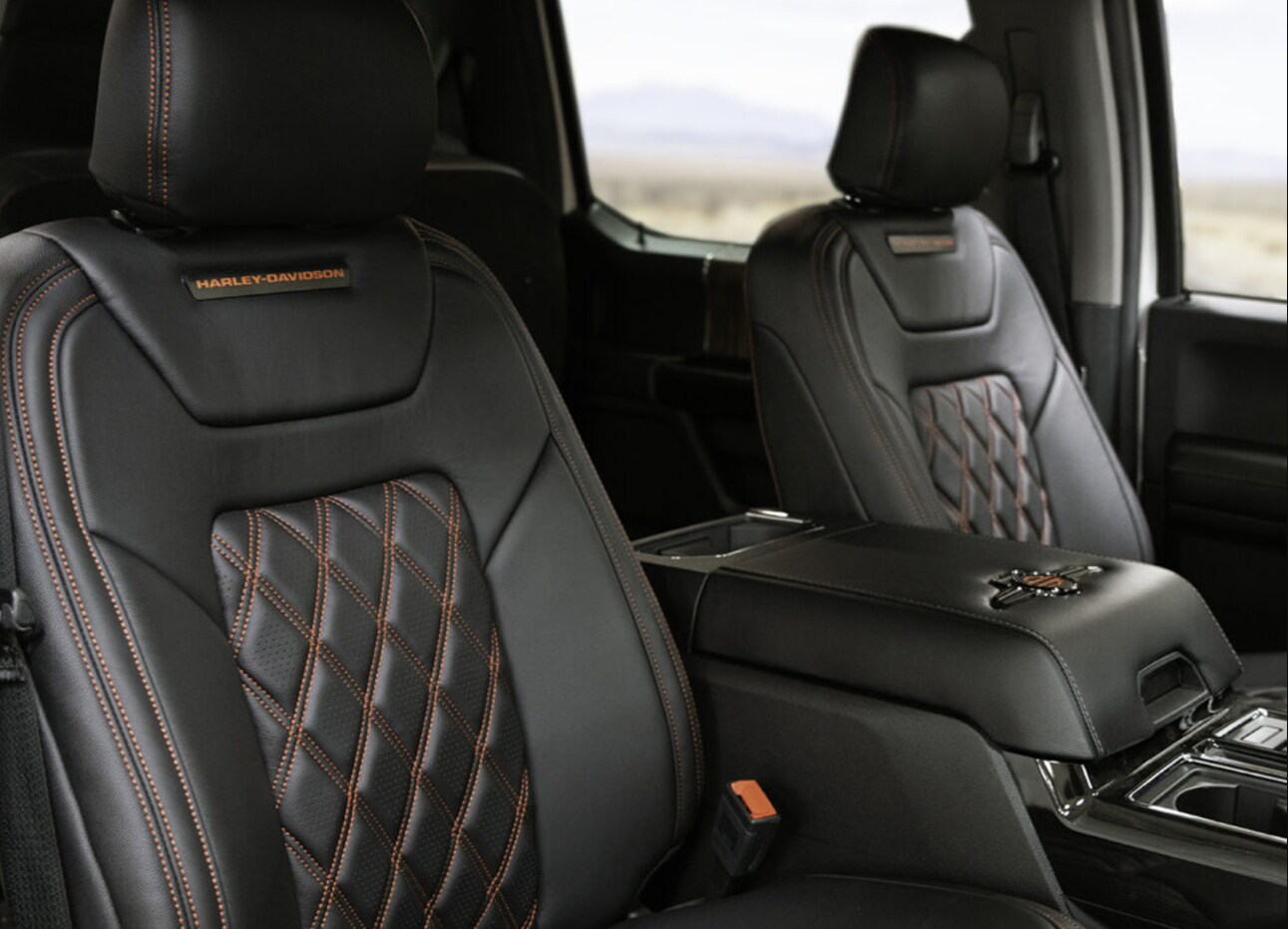 Ford F250 Super Duty Harley Davidson-3.PNG A view of the interior seating of the 2022 Ford F250 Super Duty Harley Davidson showing the black leather quilted seating with contrasting orange stitching and embroidered Harley Davidson Logo on the seats
