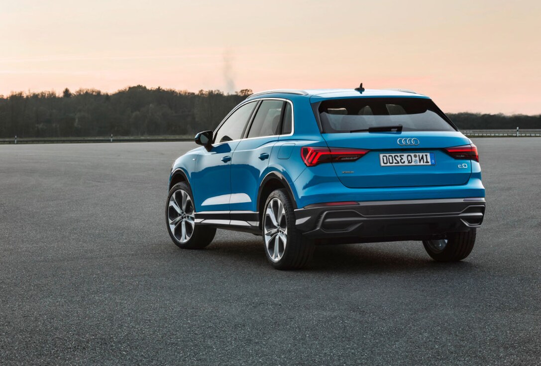 2022 Navarra Blue Metallic Audi Q3 Back 3.png The back of a 2022 Audi Q3 Parked in a parking lot facing the Sunset