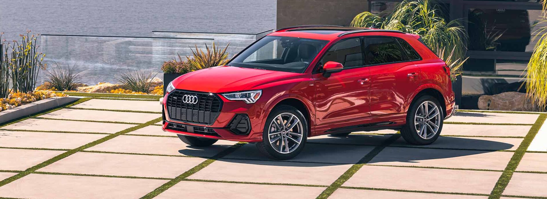 2023-audi-q3-3.PNG A profile view of a parked, red 2023 Audi Q3