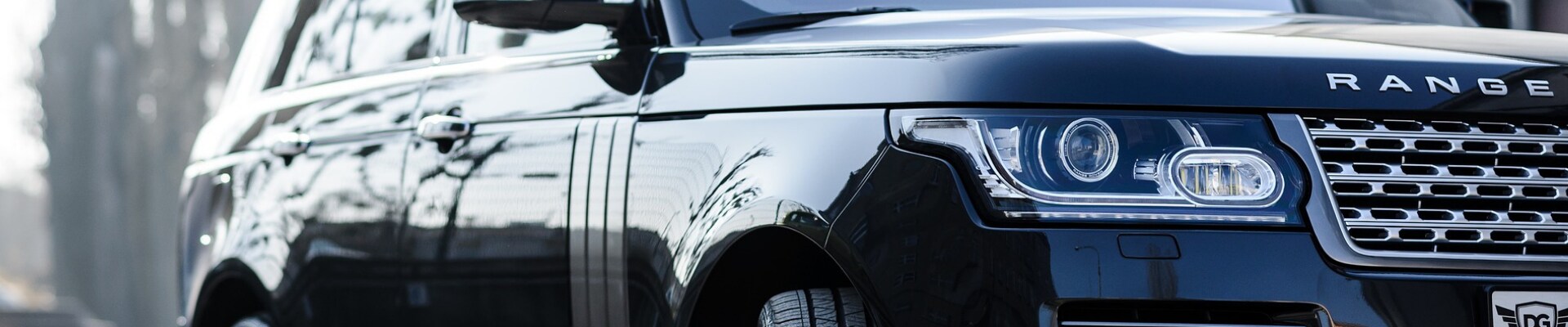 When is the best time to buy used cars in Colorado at Phil Long Dealerships.png Close up view of front passenger side of a Range Rover black used suv in Colorado Springs at Phil Long Dealerships