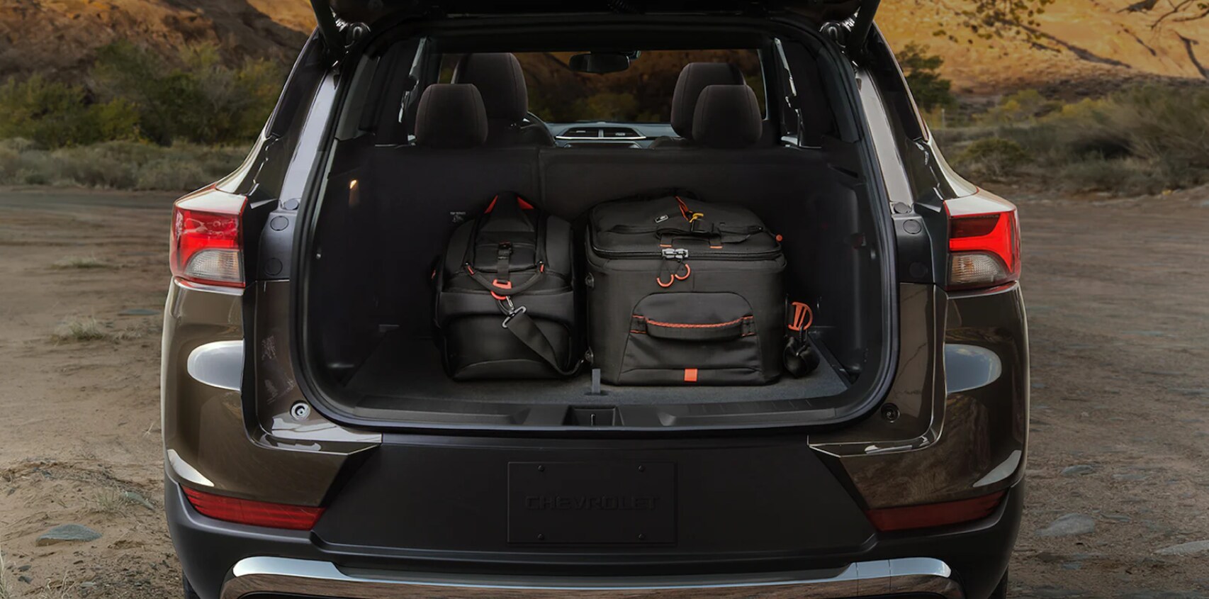 2022-Chevy-Trailblazer-3.PNG A view of the back of the trailblazer with the rear hatch open, a dark carpeted interior, and luggage sitting inside