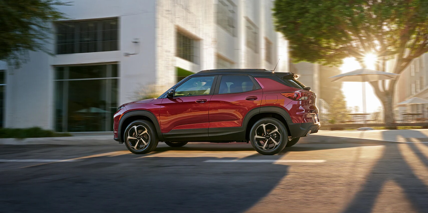 2022-Chevy-Trailblazer-5.PNG A cherry red Trailblazer speeding down an urban street in the late afternoon