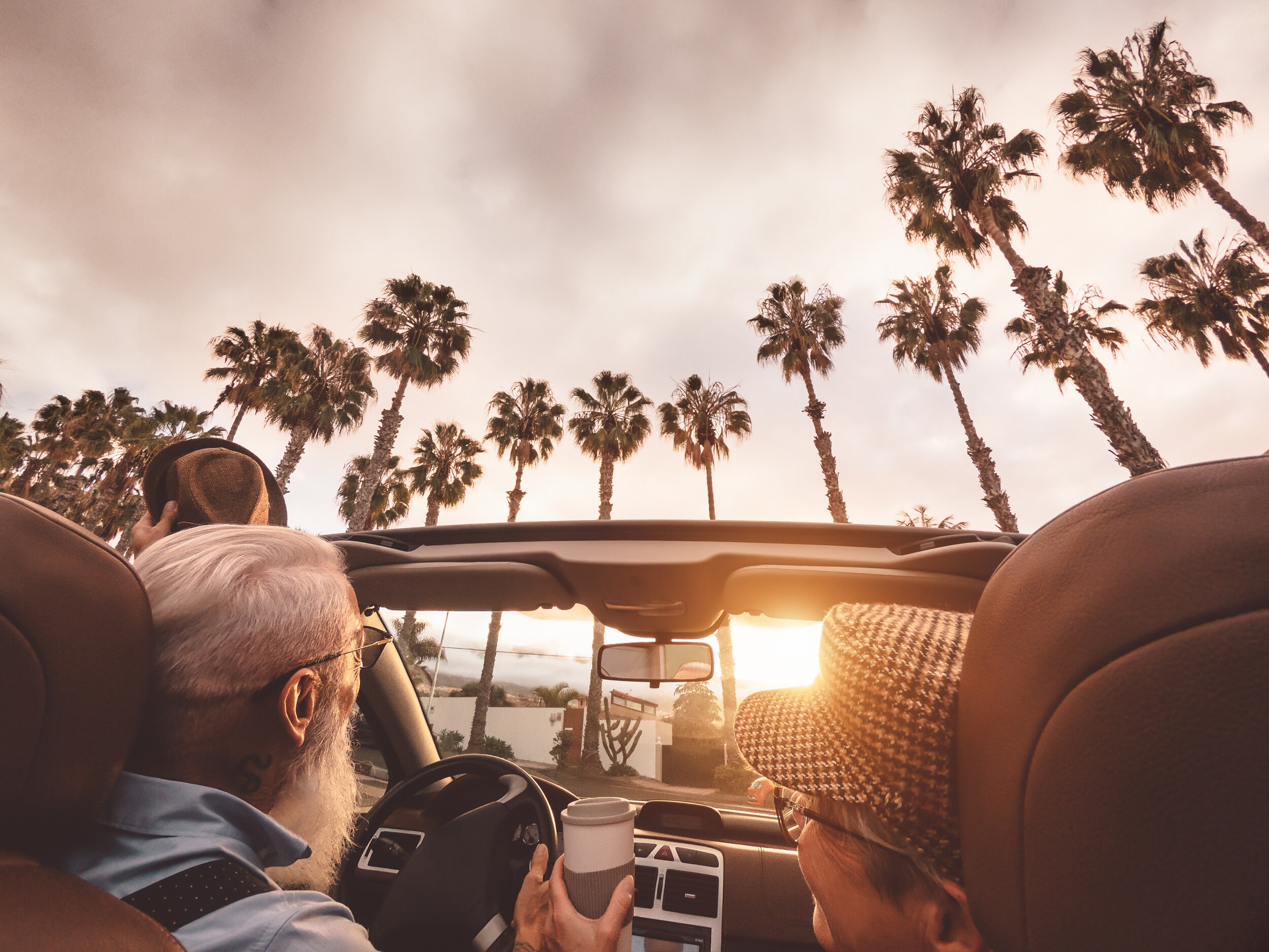 tips-to-buying-a-used-car-phil-long-dealership.jpg Elderly couple driving off into the sunset with their new certified used car