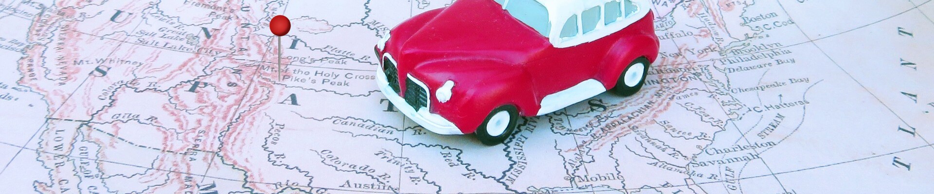 Where is the best place to buy used cars at Phil Long Dealerships.png A toy car sitting on a map of the United States with a tack pinned on the Colorado Springs area