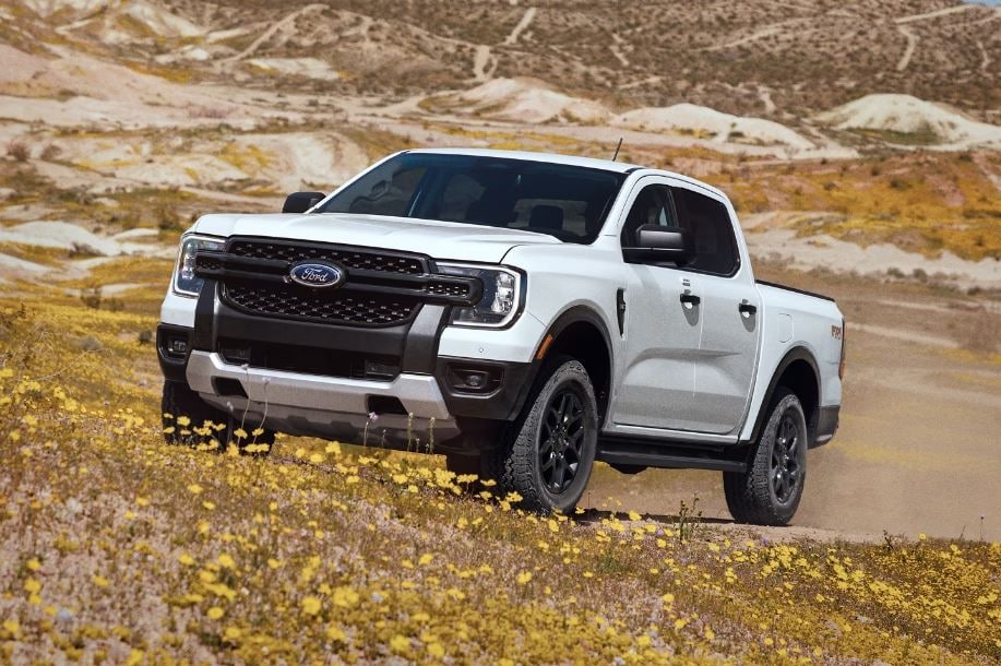 2024 Ranger.JPG A Ford Ranger driving through a rocky field.