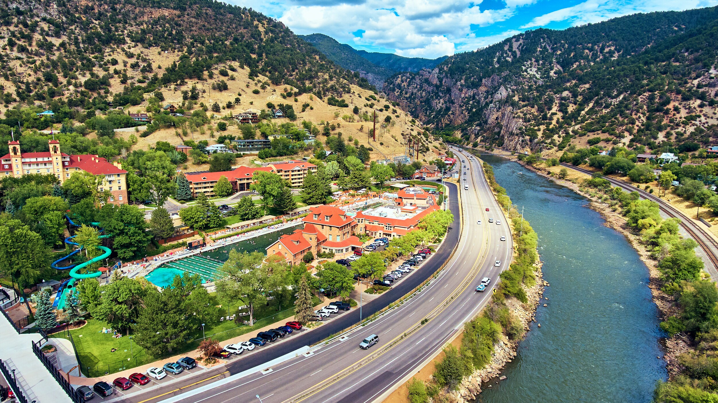 AdobeStock_228752681.jpeg A view of Glenwood Springs with the famous hot springs on the side of the interstate.