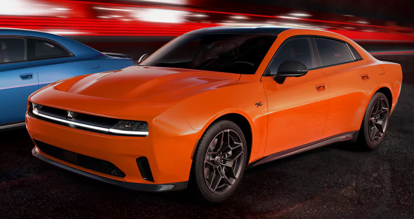 2025%20Dodge%20Charger%20Daytona.jpg Two new 2025 Dodge Charger Daytonas, one blue and one orange, zooming together with a blurred background.
