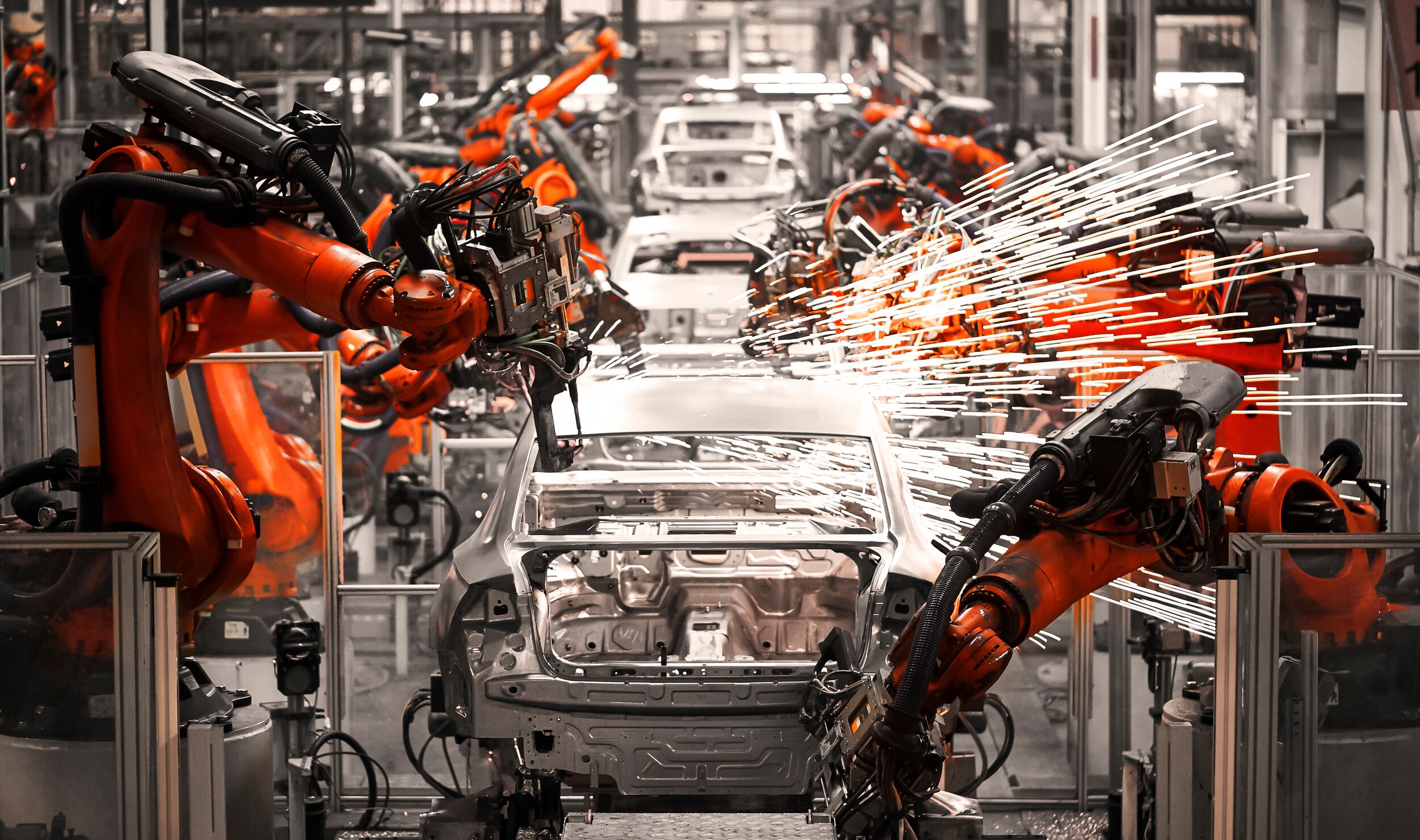 AdobeStock_237714206.jpeg A manufacturing line for new cars.