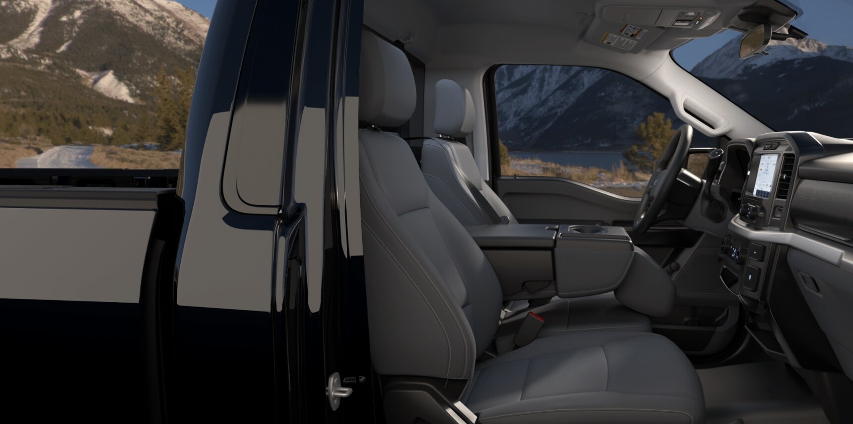 The luxurious interior of the Ford F150 is shown and has gray leather seats and center console and polished dashboard