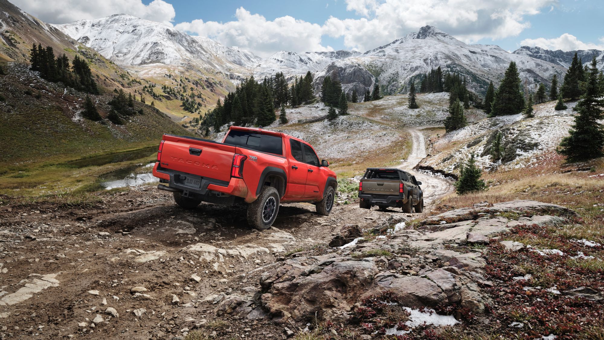 Tacoma 2024.jfif Two Toyota Tacoma's driving through an off road mountain road.