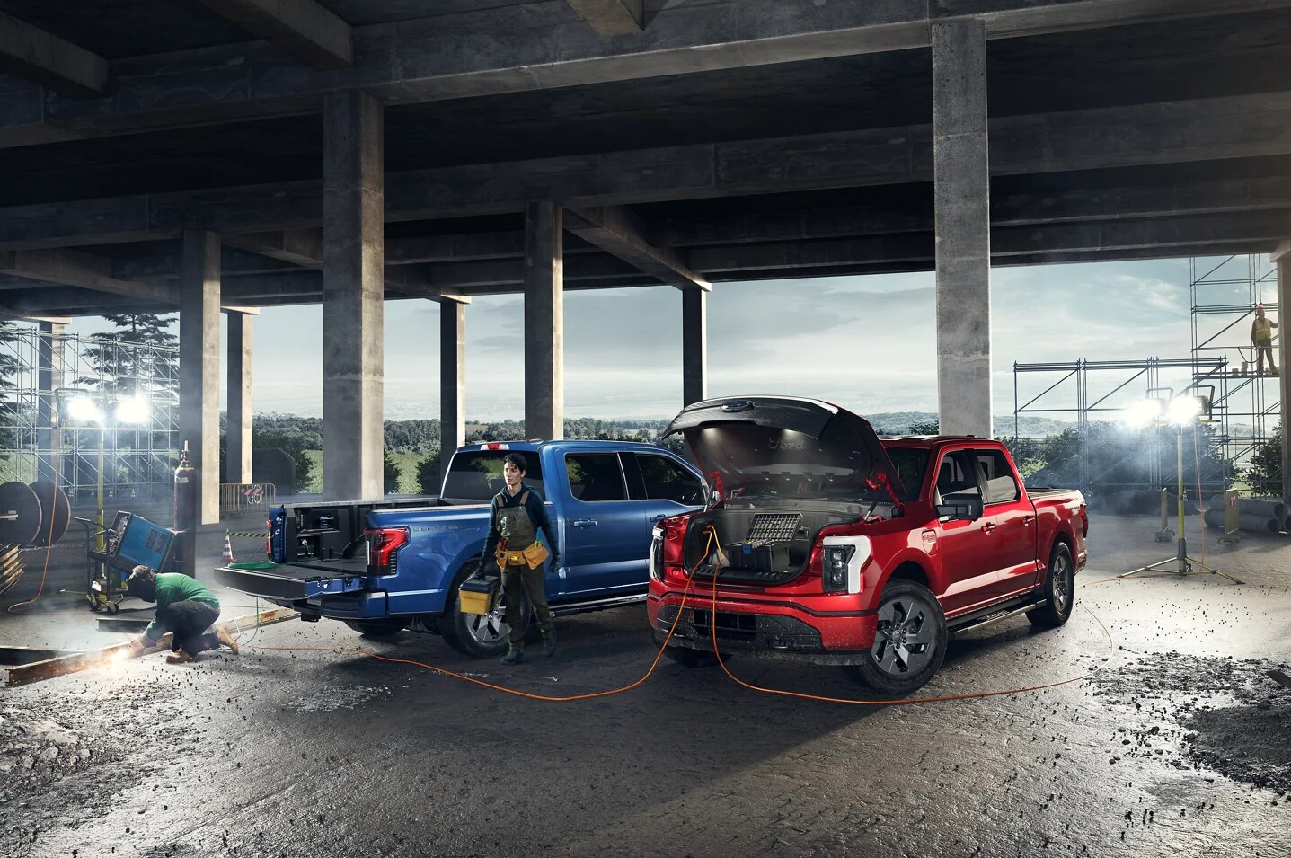 2022 Ford Lightning 4.png Two 2022 Ford Lightning Tuscks Being Charged in a mechanics shop