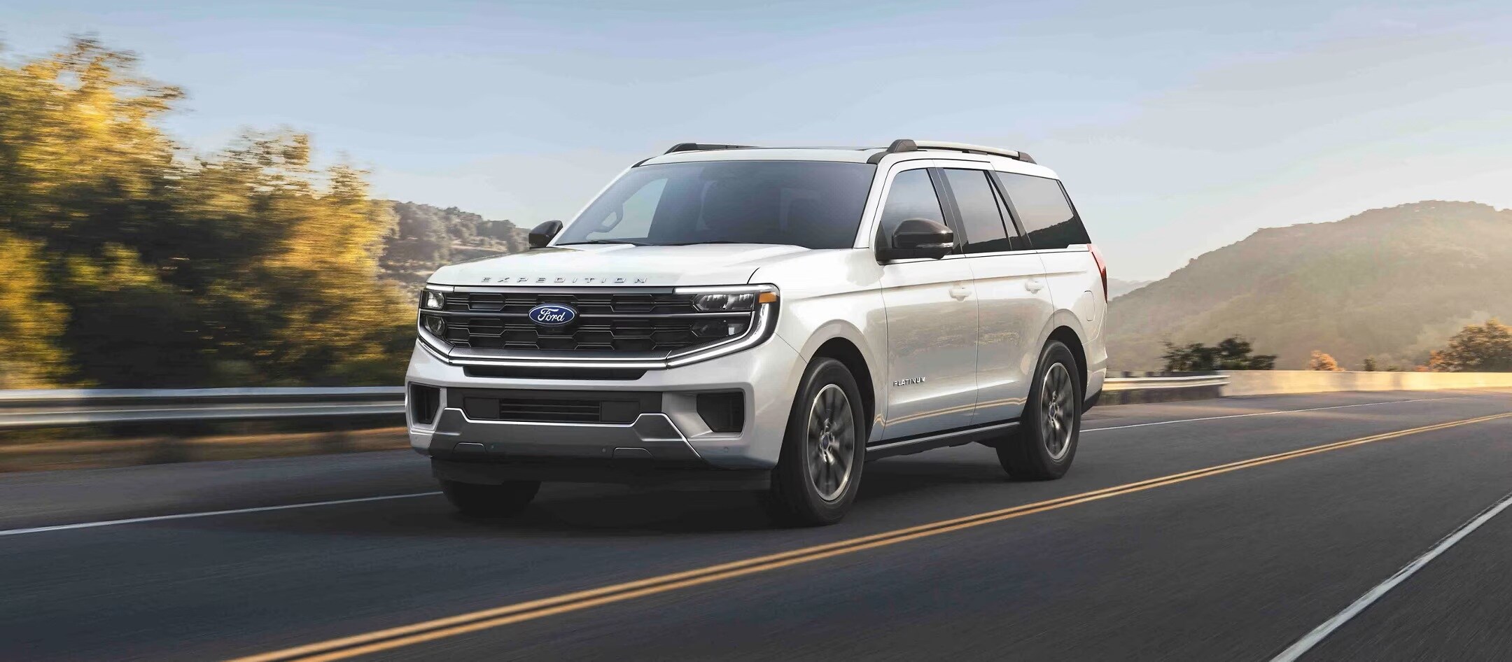 A 2025 Ford Expedition driving down a road.