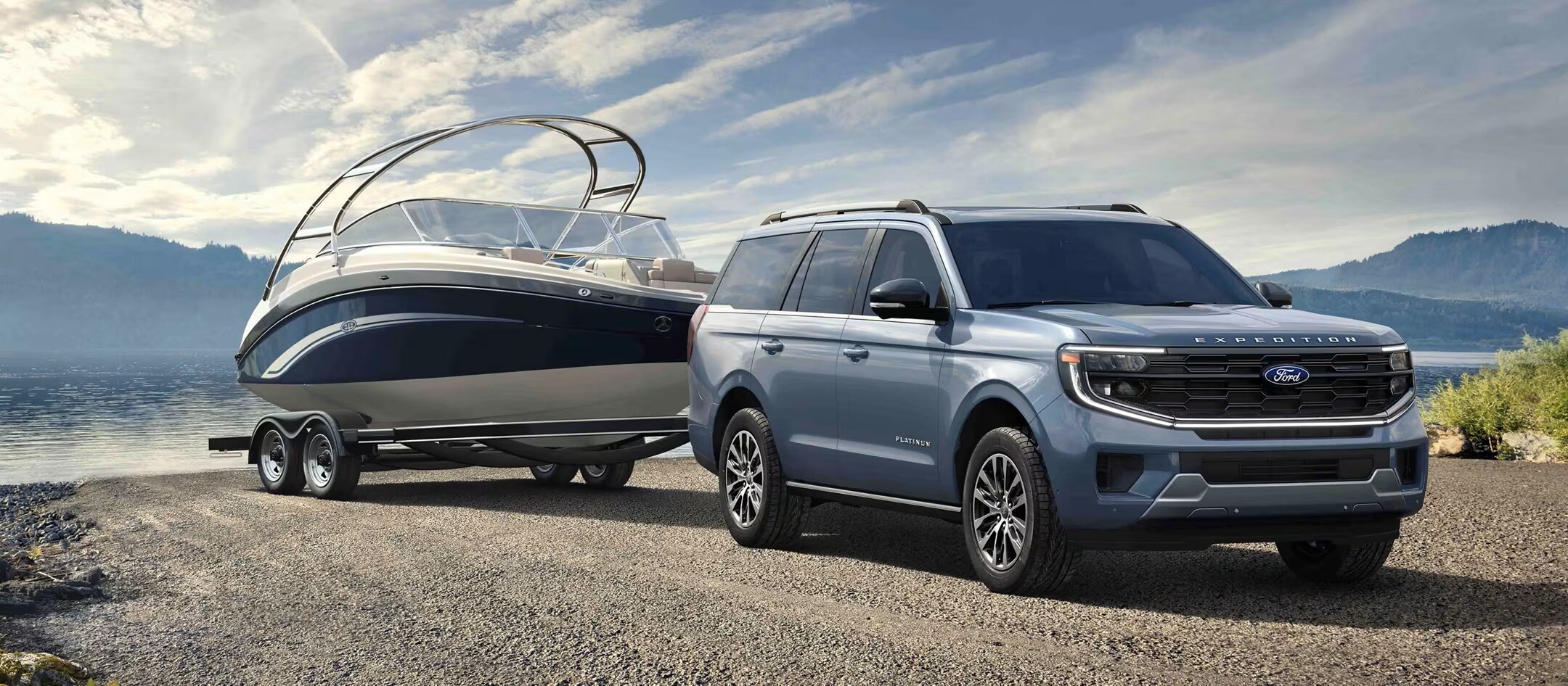 A 2025 Ford Expedition towing a boat driving down a road.