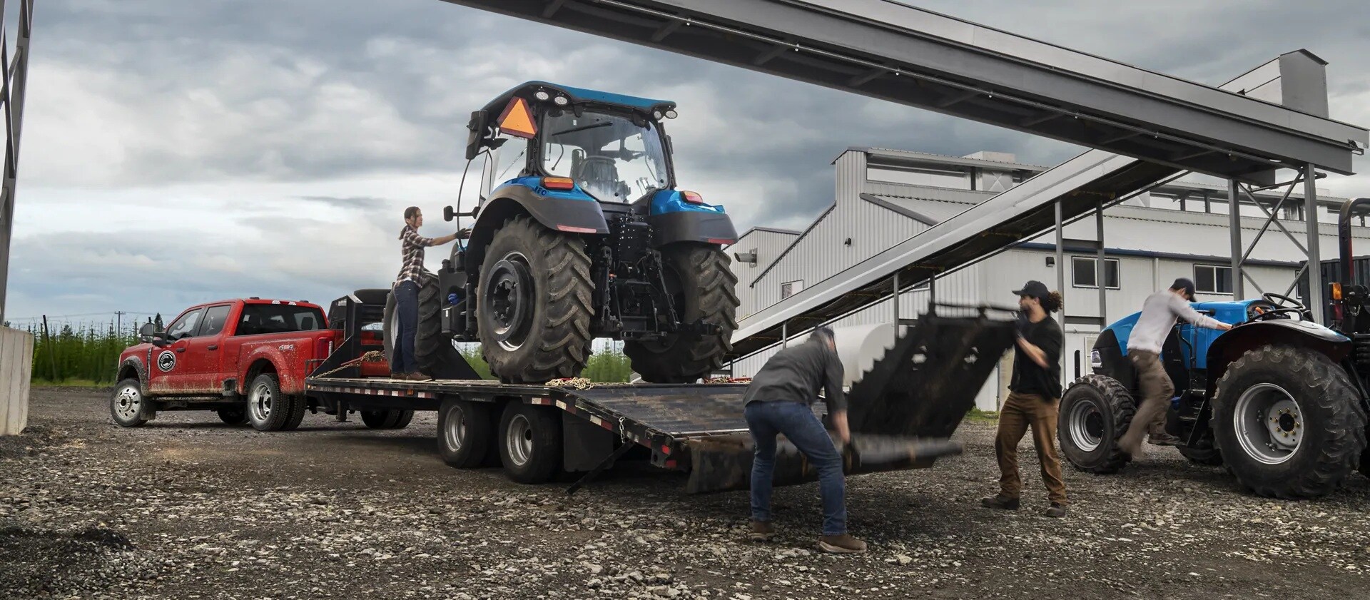 A red Ford Super Duty towing a heavy duty tractor
