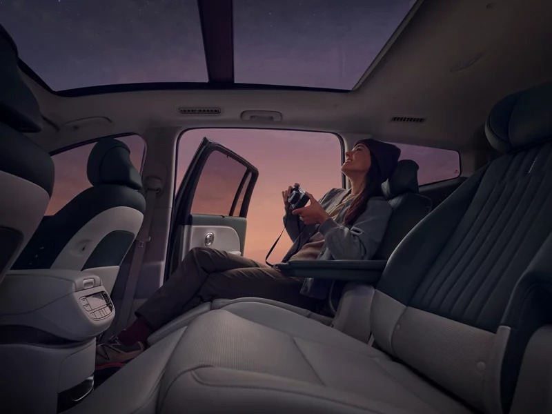 Passenger relaxing in the Hyundai IONIQ 9 second row under the panoramic roof