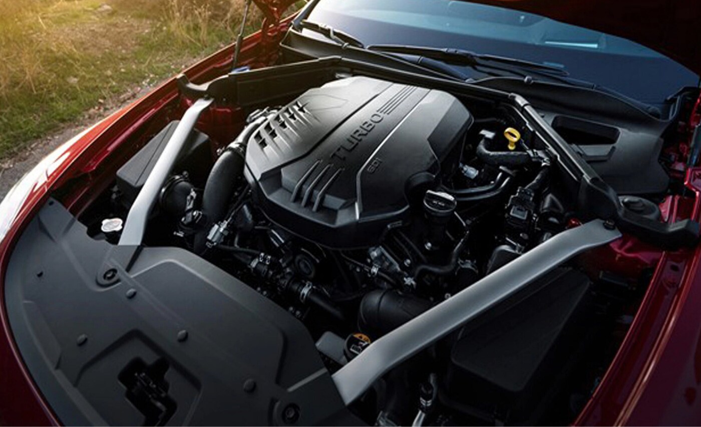 New 2021 Kia Stinger Engine.png Top down look at the 3.3L twin-turbo V6 engine under the hood of the new 2021 Kia Stinger GT