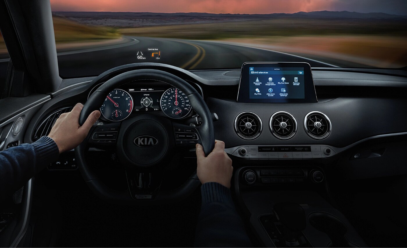 New 2021 Kia Stinger Interior.png Front interior view inside the new 2021 Kia Stinger from driver point of view showing the heads up display above the steering wheel