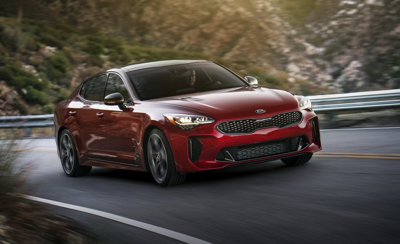 New 2021 Kia Stinger GT.png New 2021 Kia Stinger GT trim in red exterior color as it drives around the bend on a curvy mountain road