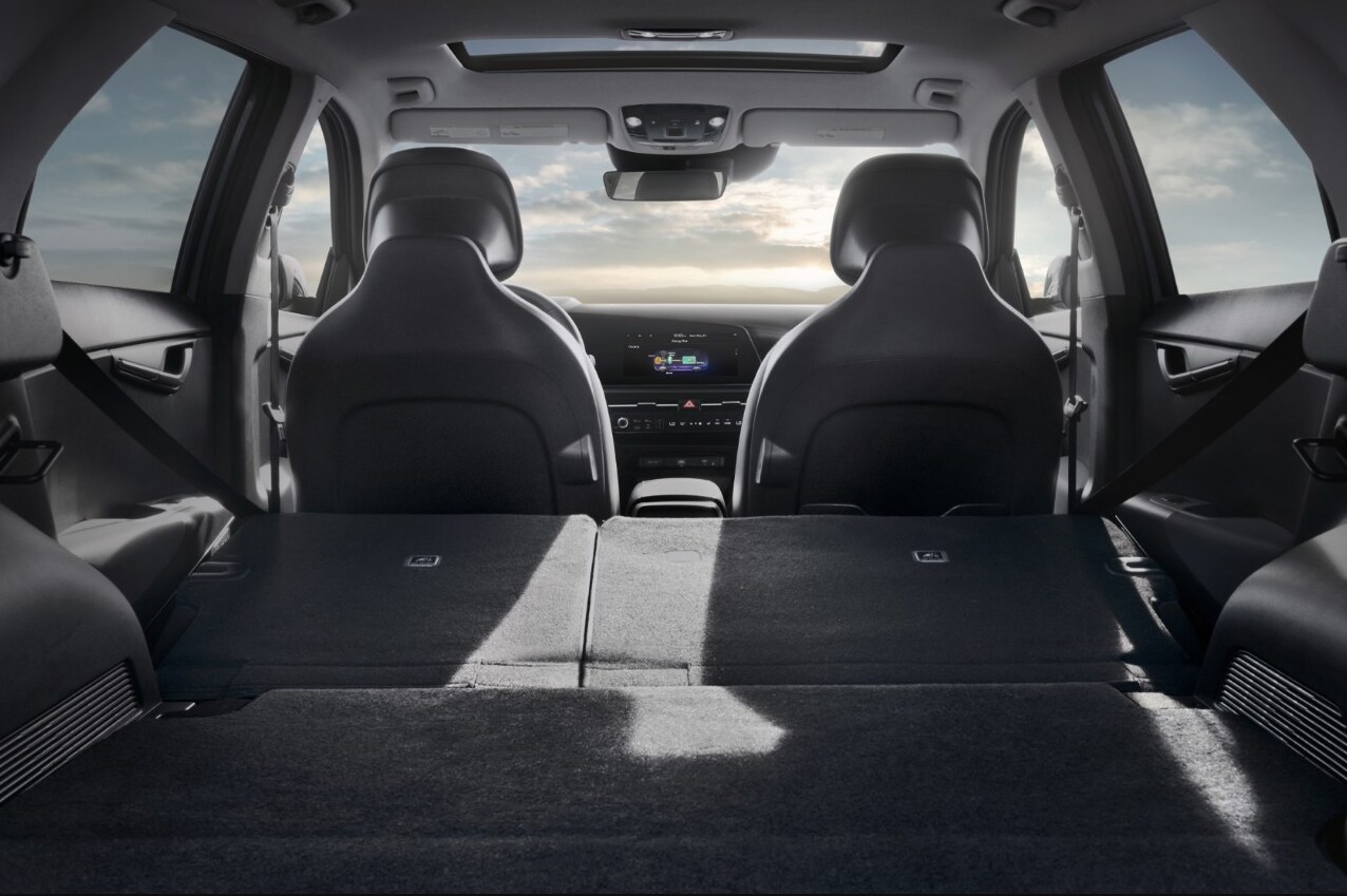 2023 - Kia - Niro - 4.PNG A view of the cargo and folded down back seat and cabin of the 2023 Kia Niro