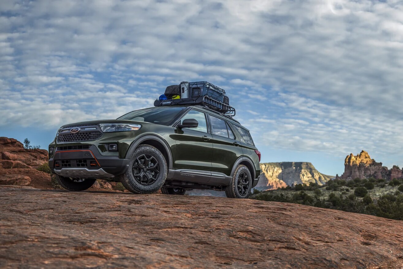 A-forest-green-2023-Ford-Explorer-sits-parked-at-a-campsite-with-two-mountain-bikes-mounted-to-the-roof.PNG A forest green 2023 Ford Explorer