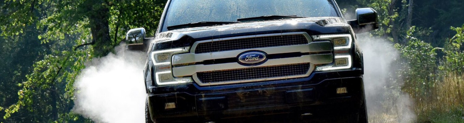 2019 Ford F-150 engine options Phil Long Ford Motor City Colorado Springs.png Close up view of the 2019 Ford F-150 front exterior pushing engine performance through thick mud